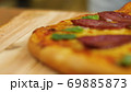 ppetizing hot pepperoni pizza lies on a tray. Close-up. Slow motion 69885873