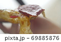 Attractive woman holding slice of pizza and biting it. Hungry girl have a dinner in fast food 69885876