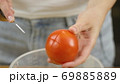 Woman cuts vegetables for salad. Cut tomatoes closeup. The concept of a healthy lifestyle 69885889