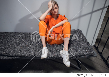 A young blonde woman convicted of armed robbery is in solitary confinement in a women's prison 69886381