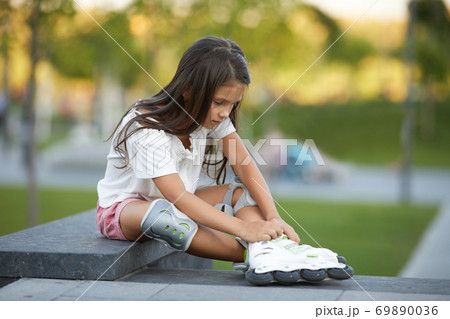 happy little child girl in roller skates 69890036
