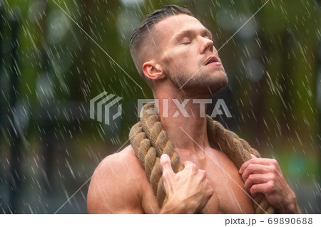Close up portrait of a sportsman having rest after hard workout outdoor. Close up portrait of a sportsman having rest after hard workout outdoor. 69890688