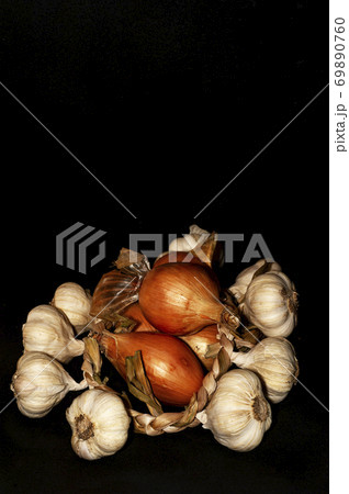 vertical photo of garlic and onion close-up on black background 69890760