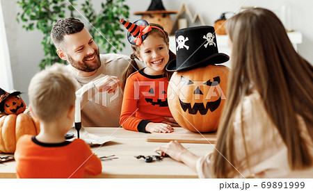 Happy family decorates the house, getting ready for the Halloween celebration 69891999