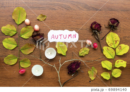 autumn message card handwriting with leaf, dried rose flowers, candle ,stick in autumn 69894140