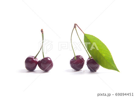 Red sweet cherry with green leaf isolate on white. 69894451