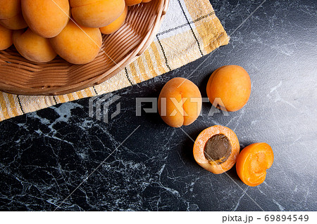 Fresh organic apricots in basket. Group of harvested apricots in basket.. Fresh organic apricots in basket. Group of harvested apricots in basket.. 69894549
