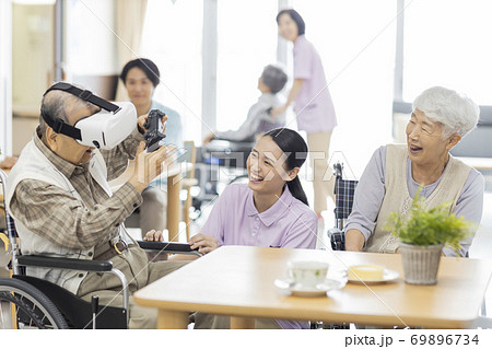 VRのゲームをするシニア男性と介護士 老人ホーム 69896734