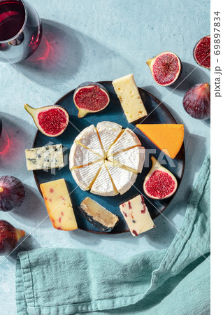 Cheese tasting. A selection of cheeses on a plate with figs, overhead shot 69897834