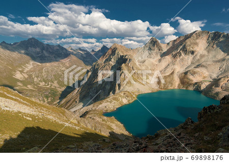 Day landscape mountain lake high in the mountains against the background of the Caucasian highlands in the North Caucasus Day landscape mountain lake high in the mountains against the background of the Caucasian highlands in the North Caucasus 69898176