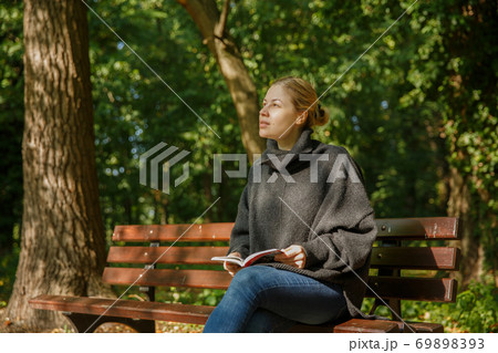girl in the park with a book 69898393