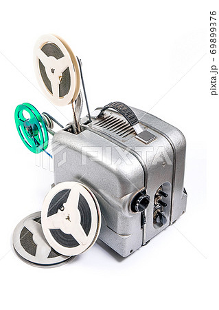 Vintage motion picture film projector and reel of motion picture film isolated on a white background. 69899376