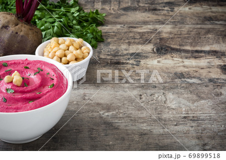 Beet hummus in a bowl on wooden table. Copy space	 69899518