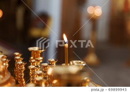 Orthodox Church. Christianity. Festive interior decoration with burning candles and icon in traditional Orthodox Church on Easter Eve or Christmas. Religion faith pray symbol. 69899943