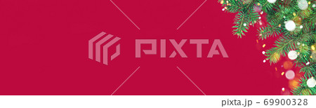 xmas banner with green fir branches and Christmas lights bokeh on red background 69900328