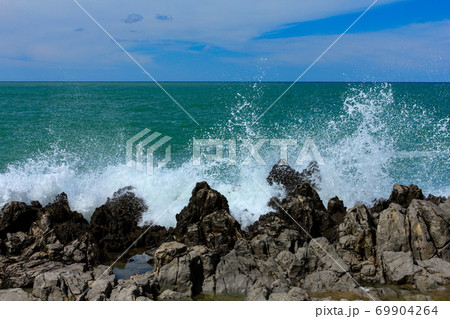 Sea waves crash and splash on rocks. Sea waves crash and splash on rocks. 69904264