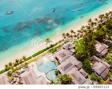 Luxury beach with hotel in Mauritius. Sandy beach with palms and blue ocean. Aerial view 69905123