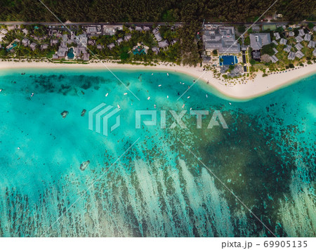 Luxury beach with resorts, palms and blue ocean in Mauritius. Aerial view Luxury beach with resorts, palms and blue ocean in Mauritius. Aerial view 69905135