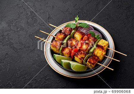Chicken Tikka at skewers in black bowl on dark slate table top. Indian cuisine dish. Indian food 69906068