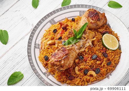 Kabsa at white wooden background. Kabsa is traditional saudi arabian cuisine dish. 69906111
