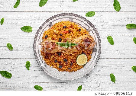 Kabsa at white wooden background. Kabsa is traditional saudi arabian cuisine dish. 69906112