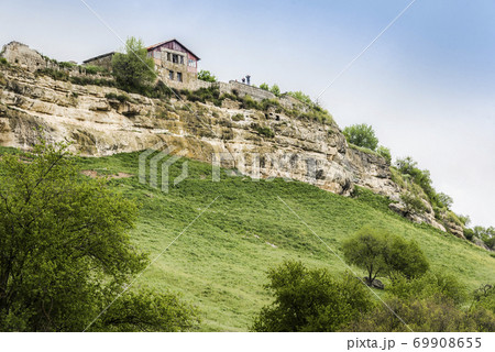 Medieval building on a high cliff in the ancient city-fortress Chufut-Kale in Crimea, Russia Medieval building on a high cliff in the ancient city-fortress Chufut-Kale in Crimea, Russia 69908655