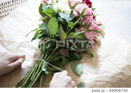 バラの花束を紐で束ねる女性の手 69908740
