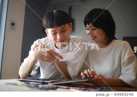 写真を見るカップル 69909240