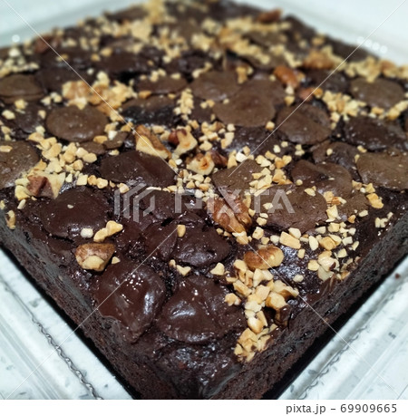 Selected focused on the chocolate & cheese cake. Rectangular in shape. Has been cut into small cubes to make it easier to eat. Selected focused on the chocolate & cheese cake. Rectangular in shape. Has been cut into small cubes to make it easier to eat. 69909665