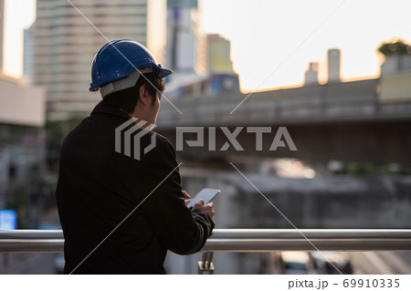 engineer using smartphone to update project plan 69910335