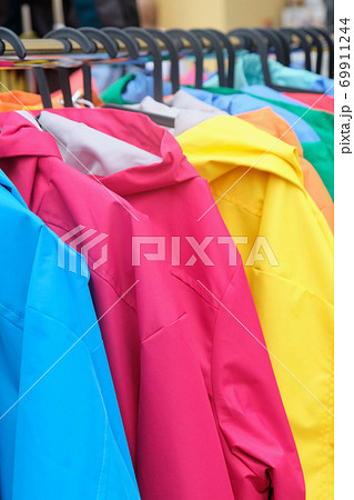 Hanger in the store with fashionable different color jackets for sale 69911244
