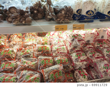 SEREMBAN, MALAYSIA -AUGUST 16, 2020: Various types of mushrooms in a transparent food package. Placed on a cooling rack and displayed to customers. 69911729