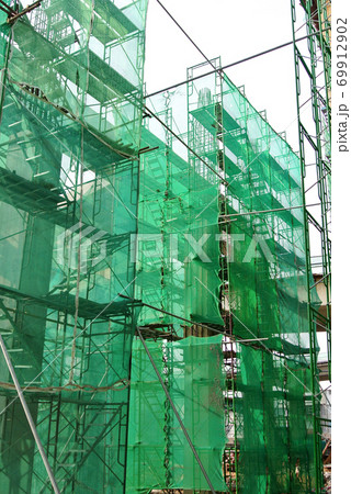 SEREMBAN, MALAYSIA -MAY 24, 2020: Temporary access and metal staircase made from staging, scaffolding and metal platform. Workers used it at the construction site to work at height. Installer to follo 69912902