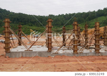 KUALA LUMPUR, MALAYSIA -SEPTEMBER 19, 2020: Column timber formwork and reinforcement bar at the construction site. Installed by construction workers. The structure supported by temporary wood support. 69913249