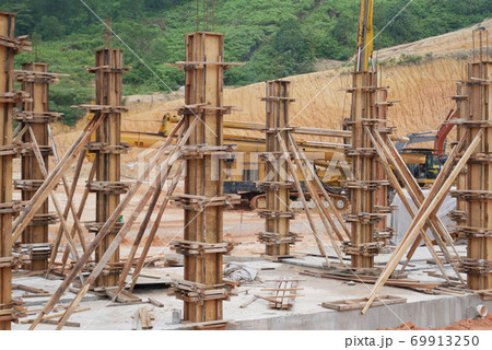 KUALA LUMPUR, MALAYSIA -SEPTEMBER 19, 2020: Column timber formwork and reinforcement bar at the construction site. Installed by construction workers. The structure supported by temporary wood support. 69913250