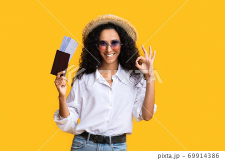 Ready For Travel. Happy woman with passport and tickets gesturing ok sign Ready For Travel. Happy woman with passport and tickets gesturing ok sign 69914386