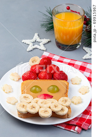Sandwich with Santa made from toast, peanut butter, strawberry, banana, grape and apple, Christmas menu for kids, vertical, copy space Sandwich with Santa made from toast, peanut butter, strawberry, banana, grape and apple, Christmas menu for kids, vertical, copy space 69915967