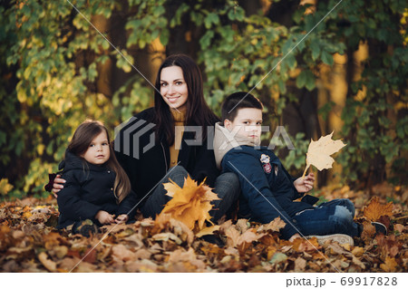 Caucasian family goes for a walk in the autumn Caucasian family goes for a walk in the autumn 69917828