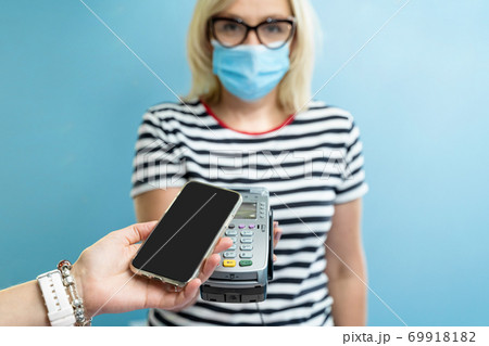 Caucasian female business owner get payment with contactless smartphone pay. pandemic smart banking 69918182