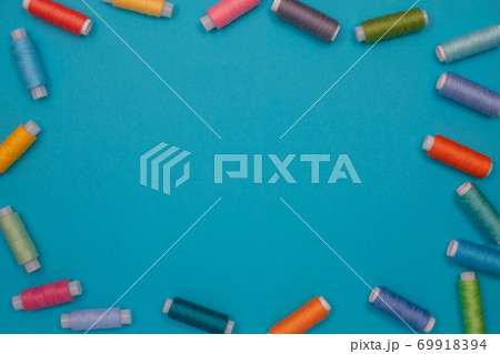 Multicolored cotton threads, spools, handmade sewing. Top view with copyspace, flat lay. 69918394