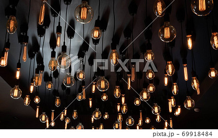 Retro Edison lamp on a black background of the ceiling. Concept idea 69918484