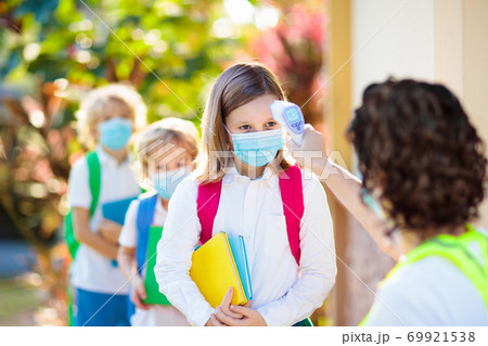 Temperature check at school. Child in mask. 69921538