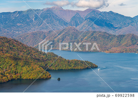 Lake Chuzenji and mountain during autumn season on bright sunny day, Nikko, Japan. 69922598
