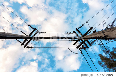 electric pole with wire uprisen angle view and blue sky background 69923969