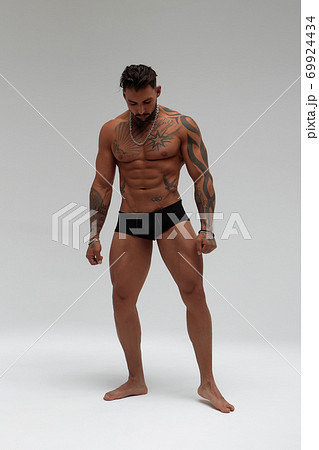 Portrait of muscle man posing in studio Portrait of muscle man posing in studio 69924434