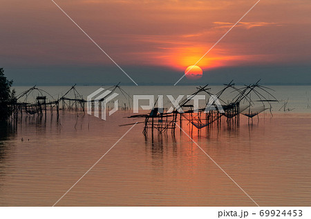 Landmark of giant fishing gears at Pakpra with beautiful sunrise. Landmark of giant fishing gears at Pakpra with beautiful sunrise. 69924453