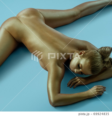 Woman art nude portrait with gold skin shot from above 69924835