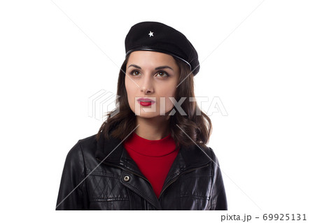 Young woman black jacket and hat with a reference to Ernesto Che Guevara on a white background Young woman black jacket and hat with a reference to Ernesto Che Guevara on a white background 69925131
