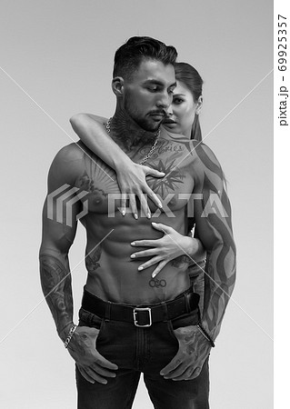 Seductive couple looking at camera Seductive couple looking at camera 69925357