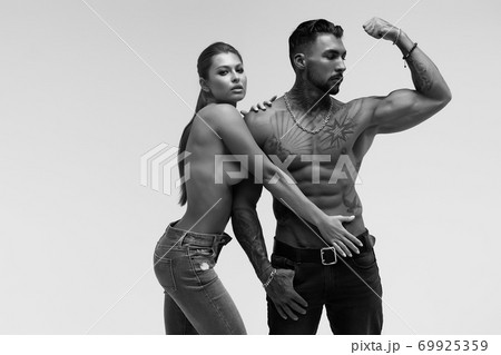 Sexy young couple in studio 69925359